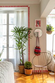 a living room filled with furniture and plants