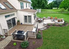 an aerial view of a backyard with patio and decking area in the foreground