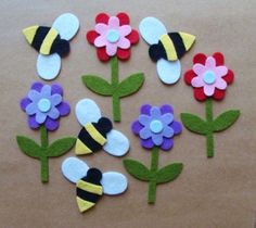 felt flowers and bees on brown paper