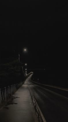 an empty street at night with the light on