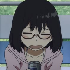 a girl with glasses holding a can of soda in her hand and looking at the camera