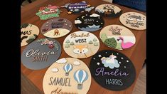 a table topped with lots of wooden cut out magnets covered in different types of name stickers