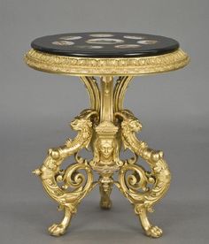 an ornately decorated table with black marble top