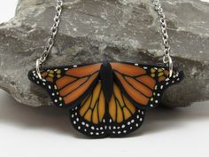 "This nature inspired monarch butterfly pendant in black and orange would make a perfect gift for a butterfly lover. I created the image with a process called caning, where different colors of clay are pieces together, reduced down to size, and sliced.  Approximately 1 3/4\" in size with a black textured backing and a 16, 18, or 20\" stainless steel chain. More butterfly items: https://www.etsy.com/shop/PasticheAccessories?ref=hdr_shop_menu&search_query=Butterfly" Polymer Clay Nature, Butterfly Items, Clay Nature, Black Polymer Clay, Necklace Orange, Space Jewelry, Hiker Gifts, Anniversary Necklace, Special Birthday Gifts