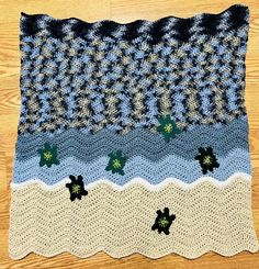 a crocheted blanket with turtle designs on it