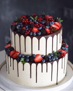 a cake with chocolate icing and berries on top