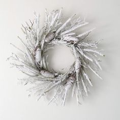 a white wreath is hanging on the wall