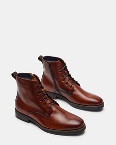 1.25 inch heel height 10.25 inch shaft circumference 5.75 inch shaft height Leather upper material Leather lining Leather sock Rubber sole Imported Steve Madden Store, Ankle Boots Men, Apparel Merchandising, Leather Socks, Men's Boots, Leather And Lace, Tan Leather, Boots Men, Rubber Sole