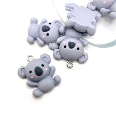 three keychains with two small grey bears on them