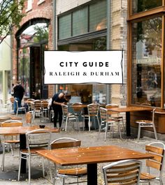 tables and chairs are lined up on the sidewalk in front of a building with a sign that says city guide