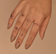 a woman's hand with tattoos on it and a star, moon and crescent