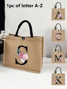 the bag has flowers on it and is next to four small bags with letters in them