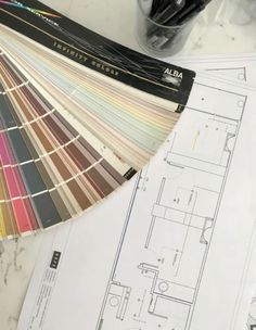 the interior design and color scheme is displayed on top of some paper with pencils next to it