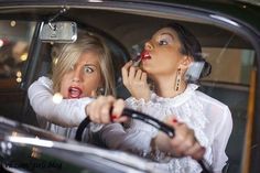 two women sitting in a car talking on the phone