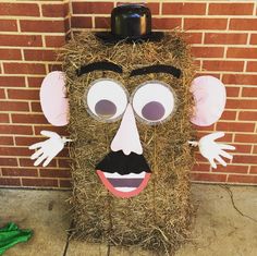 a hay bale with a face made to look like a man