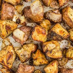 roasted potatoes on a baking sheet ready to be cooked in the oven with seasoning