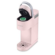 a pink coffee maker with its lid open