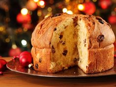 there is a cake that has been cut in half on a plate with christmas decorations around it