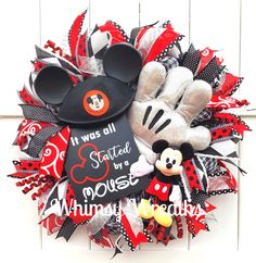 a mickey mouse wreath is hanging on the wall