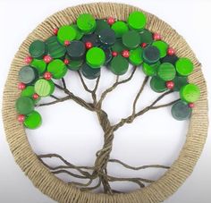 a tree with green and red buttons on it's branches is in a circle