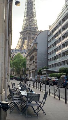 tables and chairs on the sidewalk in front of the eiffel tower, paris