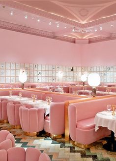 a pink restaurant with lots of tables and chairs