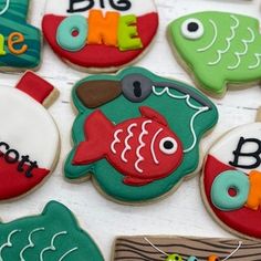 decorated cookies are arranged in the shape of fish and marine life, with words on them