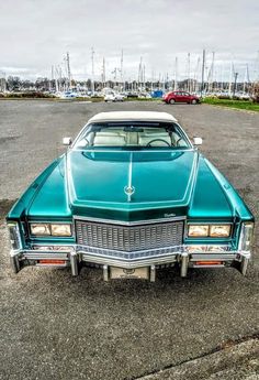 an old car parked in a parking lot