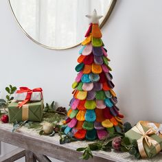 a multicolored christmas tree sitting on top of a table