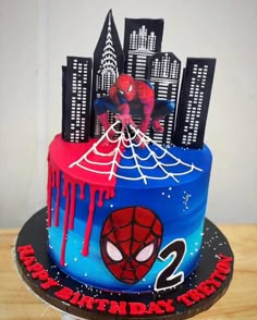 a spiderman themed birthday cake on a table