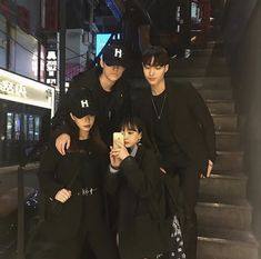 three young people taking a selfie in front of some stairs