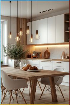 a dining room table with chairs and lights hanging from the ceiling