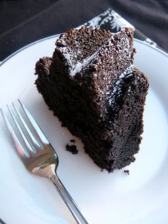 a piece of chocolate cake on a plate with a fork