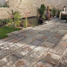 an outdoor patio area with chairs and water feature