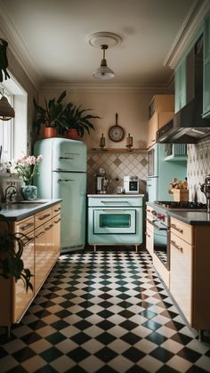 an old fashioned kitchen with green appliances and black and white checkered tile flooring