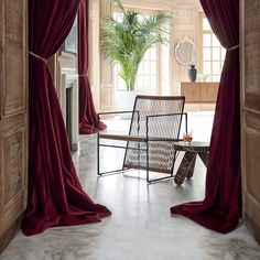 an open door leading to a living room with red curtains