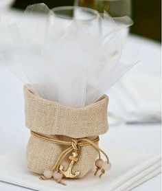 a napkin holder with some white feathers in it