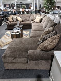 a living room filled with lots of couches and pillows on top of each other