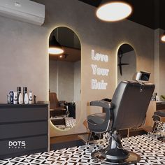 a hair salon with mirrors and lights on the wall, chairs in front of them