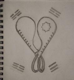 a drawing of a pair of scissors in the shape of a heart on a notebook