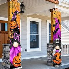 two decorated pillars in front of a house with pumpkins and jack - o'- lanterns on them