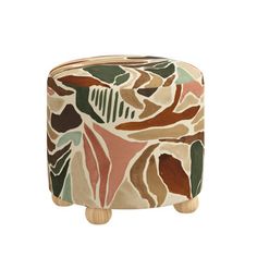 a small stool with an abstract design on it's sides and wooden legs, in front of a white background