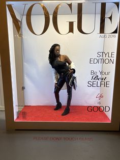 a woman standing in front of a window display