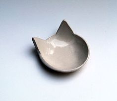 a small white bowl sitting on top of a table