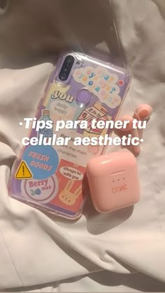 a pink phone case with stickers on it