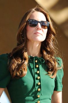 a woman wearing sunglasses and a green dress