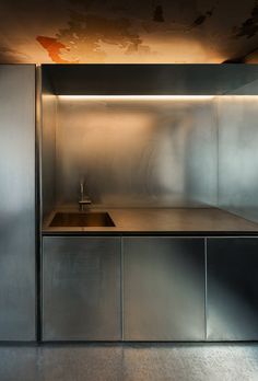 a kitchen with stainless steel cabinets and a sink