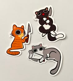 three stickers depicting cats and mice on a white surface with one cat holding a knife