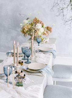 the table is set with blue and white dishes