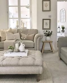 a living room filled with furniture and windows